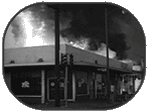 A burning building in Universal Newsreel, "Troops Patrol L.A., Damage Heavy in Coast Riots" (1965).